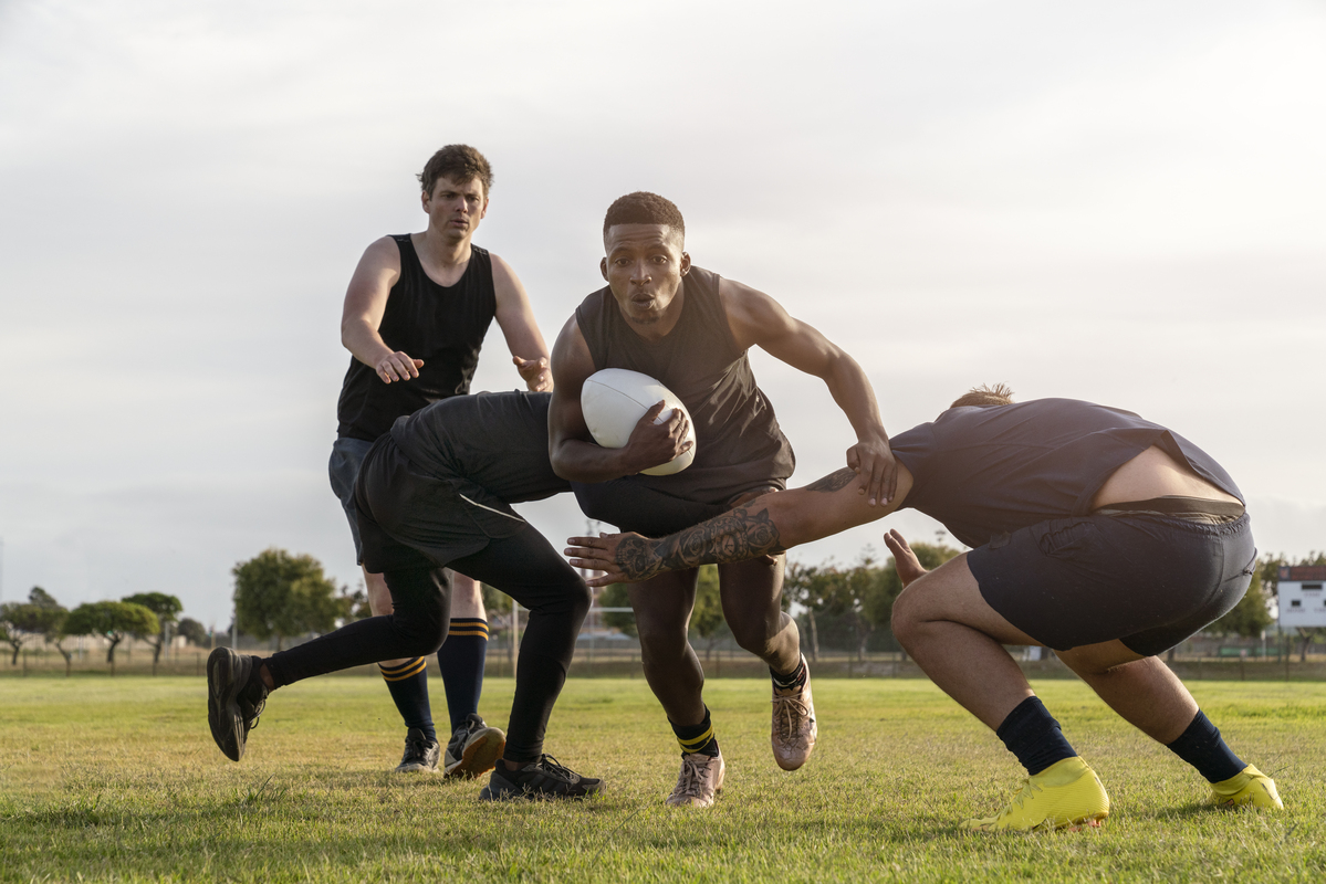 Men playing rugby league on a field during an international match